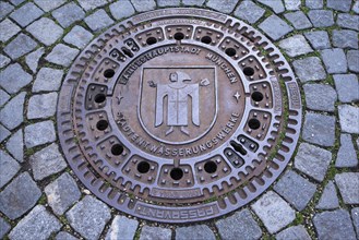 Manhole cover with Munchner Kindl