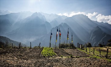 Buddhist prayer flags in front of Himalaya Mountains at sunrise