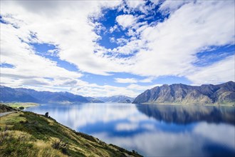 Cloudy sky with water reflections in Lake Hawea