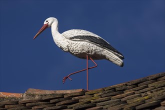 White stork figure on a roof