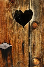 Wooden toilet door with little heart