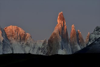 Snow-covered massif of Cerro Torre at sunrise