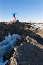 Man stands at Continental Rift between North American and Eurasian Plate