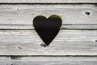 Heart-shaped hole in a wooden lodge