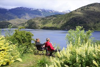 Couple on camping chairs at Lago Tranquilo