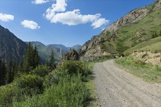 Gravel Road through mountains across Naryn gorge