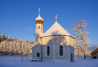 Snow-covered Nikolauskapelle in the morning light