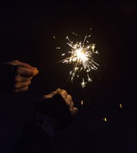 Burning sparklers in hands