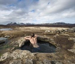 Young man in a hot spring