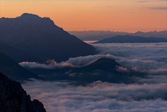 Mountain peak with sea of fog at sunrise