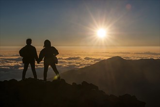 Tourists in backlight waiting for sunset on top of Haleakala National Park