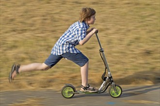 Boy is riding scooter