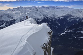 Ski tourers on the snow-covered ridge to the Alvier