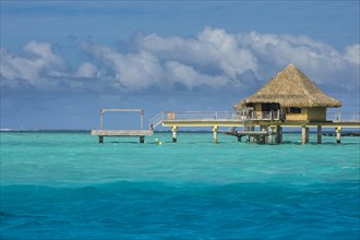 Overwater bungalows on stilts in luxury hotel