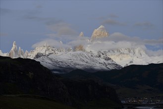 Snow-covered mountain range of the Fitz Roy and Cerro Torre with clouds at dawn