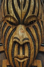 Traditional wood carved mask in the Te Puia Maori Cultural Center