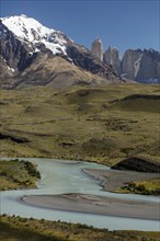 Snow covered peaks of the granite mountains Torres del Paine with the Rio Paine glacial river