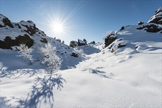 Sun shines on snow-covered lava field