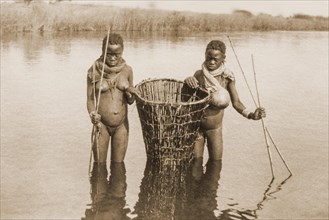 Two Ovambo girls in a river while fishing