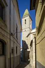 Narrow alleyway with bell tower of the church of San Nicola