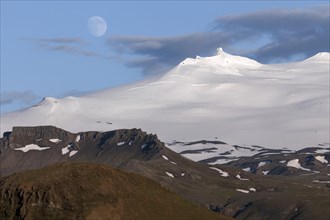 Snow-covered Snaefell volcano with Snaefellsjokul glacier and full moon