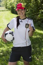 Young woman, football fan wearing a Germany cap and jersey
