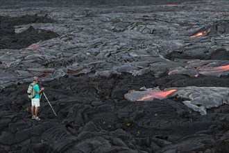 Photographer taking pictures of low viscosity lava