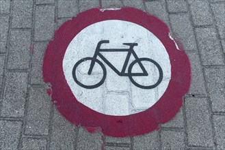Painted prohibition sign for bicycles on the pavement