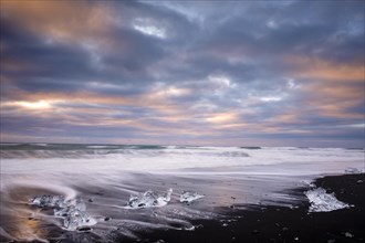 Ice, chunks of ice on lava beach near Jokulsarlon