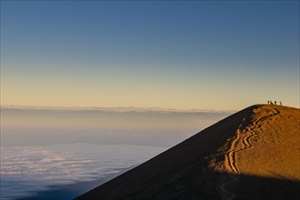 Tourists on a volcanic cone on top of Mauna Kea