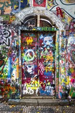 Brightly painted door with graffiti