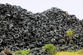 Old car tires lying on a pile for recycling