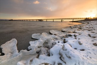 Sunrise with ice and snow on the shore of Lake Constance