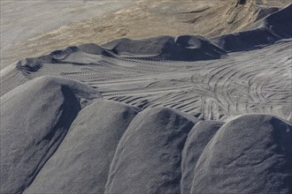 Sand heaps and excavator tracks in the basalt quarry