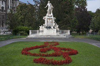 Red flowers arranged as violin key with Mozart monument