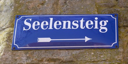 Sign with street name Seelensteig on a wall
