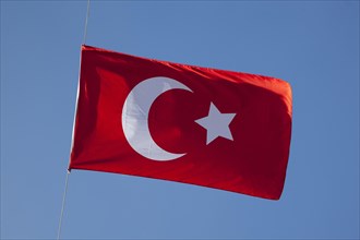 Turkish flag against blue sky