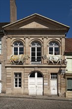 Former slaughterhouse with two bull figures on facade