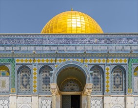 Decorated facade with mosaics and golden dome