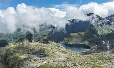 Clouds passing over a ridge with mountain lakes