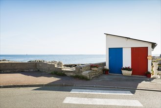Garage by the sea painted in French national colours