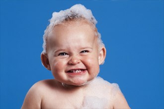 One year-old girl with bath foam on her head