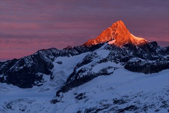 Zinalrothorn with snow in red dawn glow