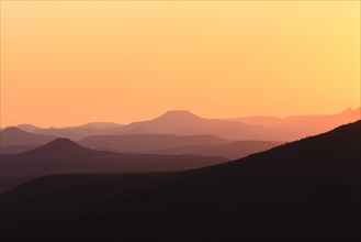 Staggered mountains at sunset
