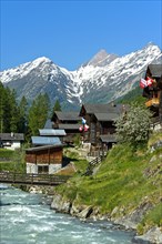 Listed townscape with Swiss chalet houses in front of Valais Alps