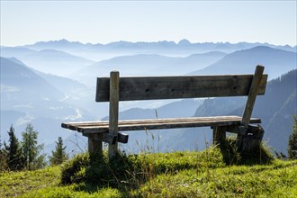 Wooden bench overlooking Schladming Tauern