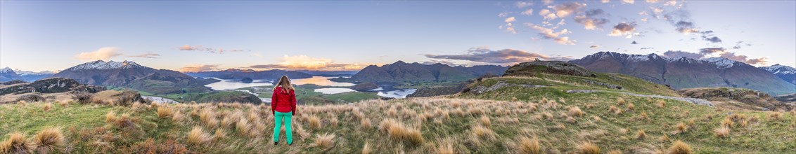 Hiker overlooking Lake Wanaka and mountains