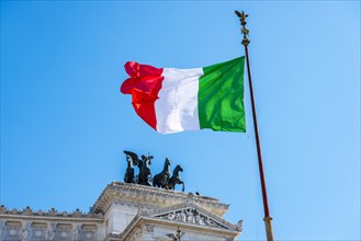 Italian flag drifting in front of Monumento Nazionale a Vittorio Emanuele II