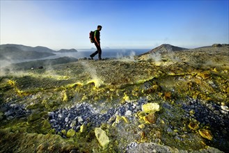 Hiker on the Gran Cratere walks through sulphur fumaroles