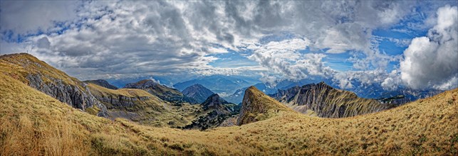 Panorama with bizarre cloudy sky from the summit of Hochiss in the Rofan Mountains with Dalfazer walls